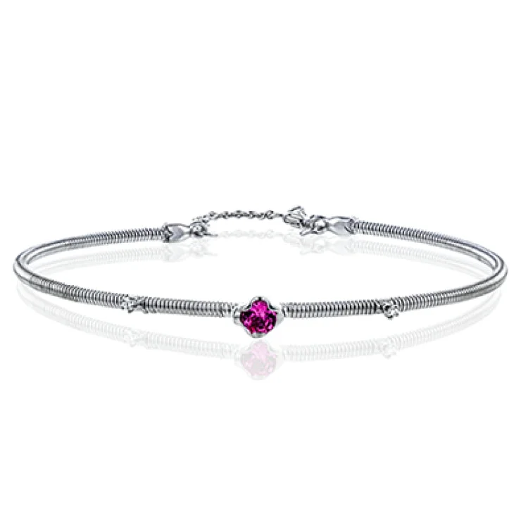 Women’s gold charm bracelets-This 18K white gold coil bracelet with a chain lock closure, features a faceted spinel gemstone 0.24 ct., and diamond accent