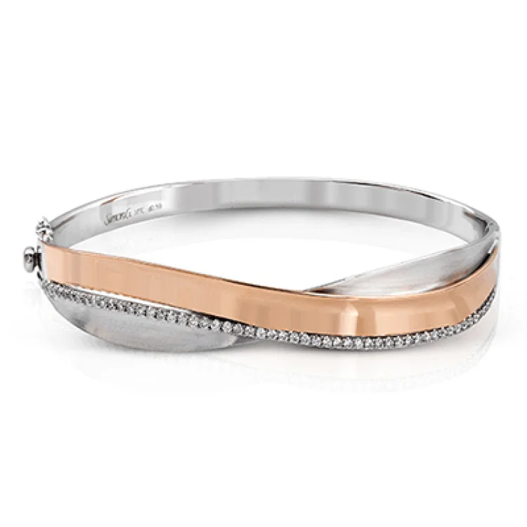 Women’s chunky bangles-This two-tone 18k rose and white gold bracelet makes a statement with .59 ctw of white diamonds and an overlapping design.