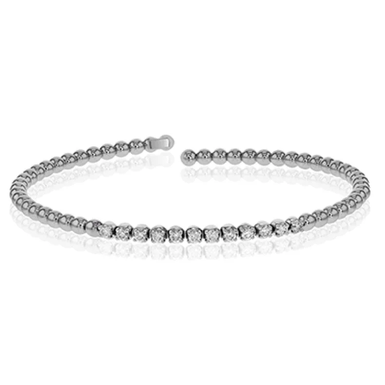 Women’s gold cuff bracelets-This 18k white gold bangle bracelet is perfect for stacking with .41 ctw of shining white round brilliant diamonds.