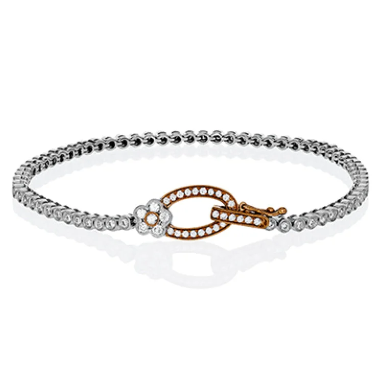 Women’s delicate bracelets-This two tone 18k white and rose gold buckle bracelet contains .98 ctw of white round brilliant diamonds, a .02 ct pink diamond, and a tiny flower design.