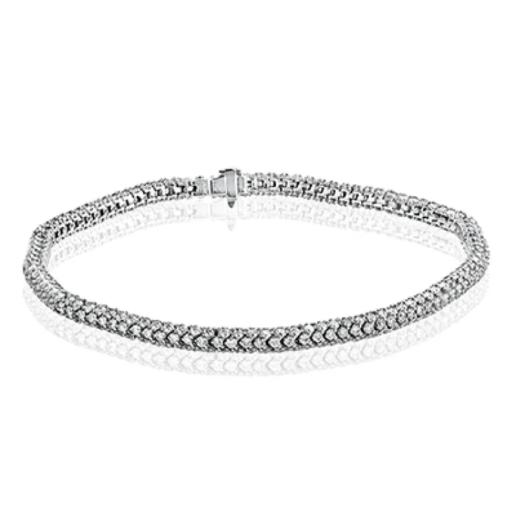 Women’s chunky bangles-This sinuous 18k white gold bracelet winds comfortably around the wrist, sparkling with an astounding 6.69 ctw of white diamonds.