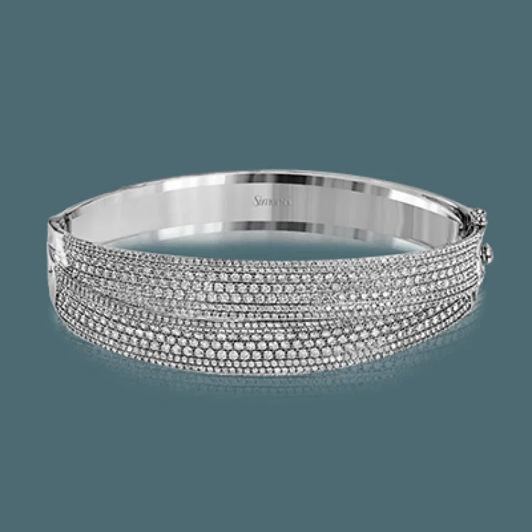 Women’s cuff bracelets-This striking bangle bracelet contains a stunning 4.69 ctw of white diamonds set into a 18k white and rose gold design.