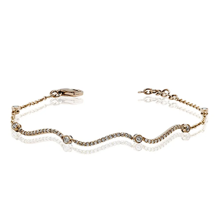 Women’s pearl bangle bracelets-This curving gold bracelet is incredibly comfortable to wear due to its flexible design that sparkles with .50 ctw of white diamonds.