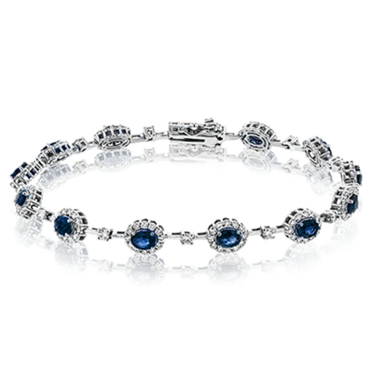 Women’s sterling silver bracelets-This 18K white gold bracelet features 2.68 ctw of oval sapphires each surrounded by white diamonds 1.42 ctw., 7