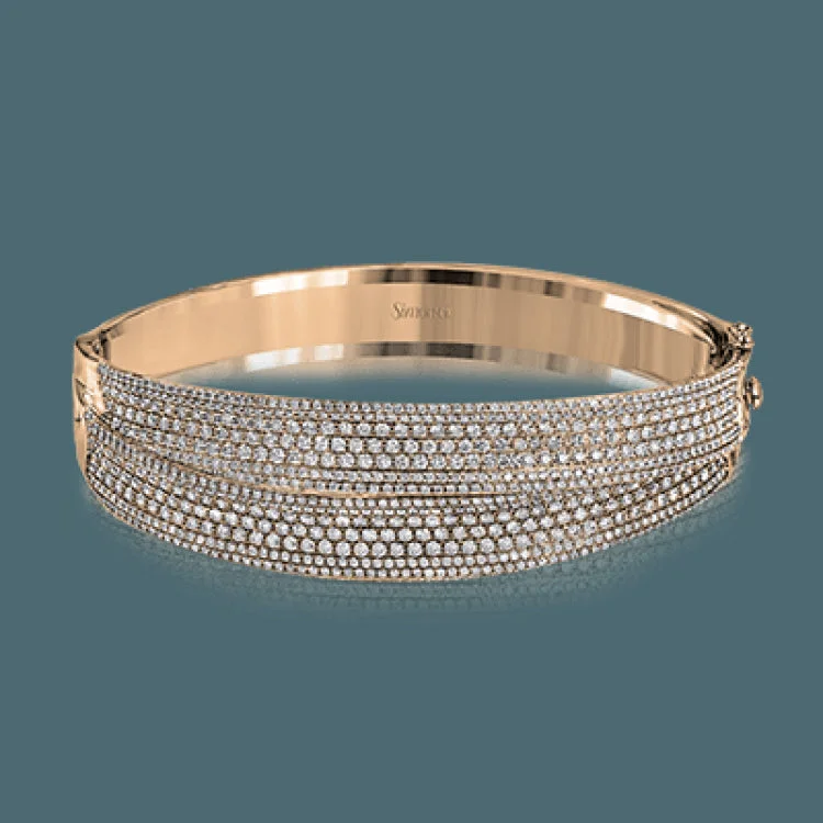 Women’s bangle bracelets-This striking bangle bracelet contains a stunning 4.69 ctw of white diamonds set into a 18k white and rose gold design.