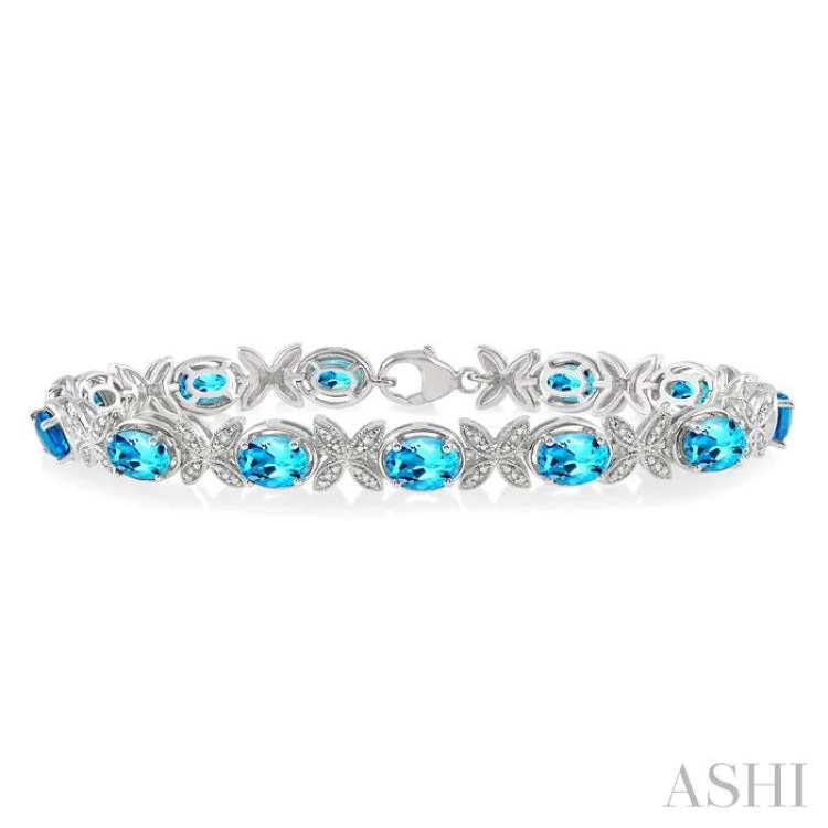 Women’s personalized bracelets-1/10 ctw Round Cut Diamond & 7x5MM Oval Cut Blue Topaz Semi Precious Bracelet in Silver