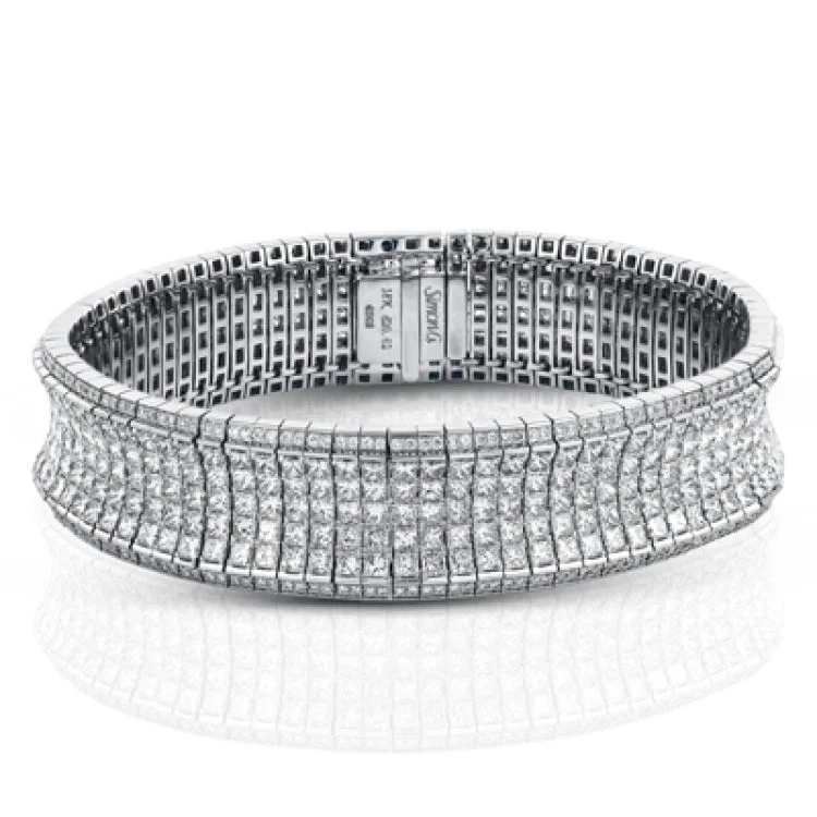 Women’s twisted bracelets-This dazzling contemporary white gold bracelet is set with 1.15 ctw of glistening round white diamonds and 19.48 ctw of princess cut diamonds.