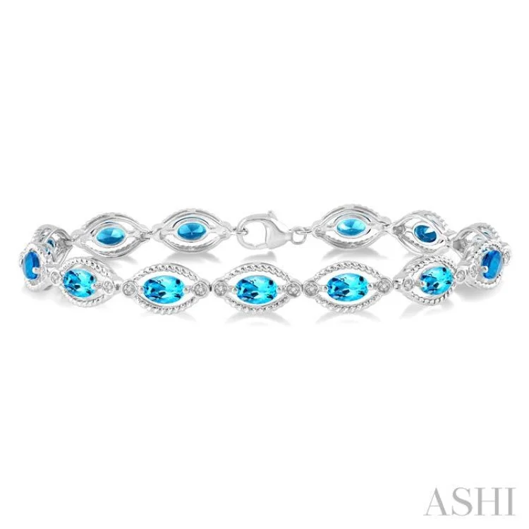 Women’s tennis bracelets-1/10 ctw Round Cut Diamond & 6x4MM Oval Cut Blue Topaz Semi Precious Bracelet in Silver